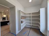 Photos are not actual home but finishes are very similiar. Wak-in hidden pantry