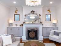 Charming living room with coffered ceiling and cabinet built-ins that frame the fireplace.