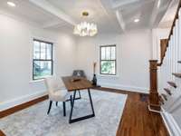 Office area off of front entryway is sure to be a focal area with the boasted coffered ceiling and oyster shell inspired lighting.  Let's call attention to the rich refurbished original hardwood floors.