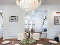 Formal dining area and a fixture to brag about!  Love the art mirrors and box trim feature walls.