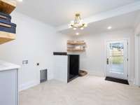 Several great features adorn this mud room/laundry room.  We must note the chevron tile, dog shower, pet station and folding station!  Let's not forget the retro light fixture that ties it all together!