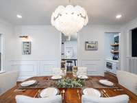 Formal dining area and a fixture to brag about!  Love the art mirrors and box trim feature walls.