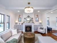 Charming living room with coffered ceiling and cabinet built-ins that frame the fireplace.