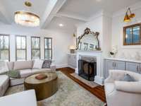 Charming living room with coffered ceiling and cabinet built-ins that frame the fireplace.