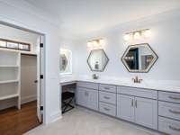 Adding an ensuite bathroom transformed the main-level master bedroom space.  At 16'x14' it provides a spacious place to rest. Walk-in closet, make-up station and shower provide a custom-designed flare to finish it off.