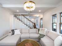 Charming living room with coffered ceiling and cabinet built-ins that frame the fireplace.