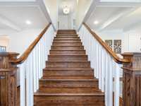 Grand staircase is the main focal of craftman style houses alike. The stain color really sets off the contrast of the white spindles. Swoonworthy!