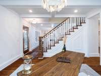 Office area off of front entryway is sure to be a focal area with the boasted coffered ceiling and oyster shell inspired lighting.  Let's call attention to the rich refurbished original hardwood floors.