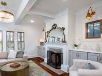 Charming living room with coffered ceiling and cabinet built-ins that frame the fireplace.