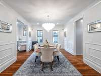 Formal dining area and a fixture to brag about!  Love the art mirrors and box trim feature walls.