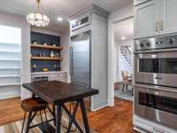 Spacious kitchen with Viking appliance package, marble countertops, custom vent hood, walk-in pantry, and coffee nook that will definitely spark a conversation!