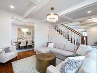 Charming living room with coffered ceiling and cabinet built-ins that frame the fireplace.