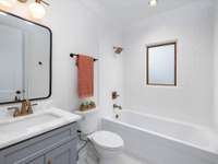 Full hall bathroom on the main level channels the historic charm of the house through mid-century style designed tile and fixtures!