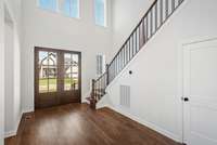 What an entrance! Through the double front doors and windows in the foyer, this home welcomes much light.  Photos are for informational purposes only and are not the actual home but a likeness.