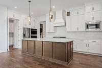 This Kitchen offers a hidden working pantry which is a favorite!   Photos are for informational purposes only and are not the actual home but a likeness.