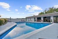 Large Inground Pool with view of outdoor covered kitchen and Living area