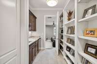 Entry hall to the Theatre room.  Door to the left is the entry to the full sized laundry room.