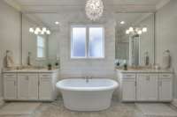 Primary bathroom with separate vanities, new shiplap accent wall, and soaker tub