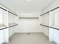 Whether you prefer to hang, fold, or display your clothing, the large walk-in closet has a spot for everything.