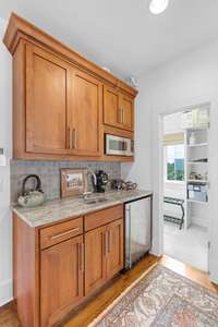 Fourth level wet bar with sink and fridge