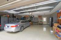 Two car garage with epoxy flooring and extra space for storage