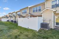 Behind the fenced in backyard is a flat area of grass. You can open your fence and extend the party out to this grassy area.