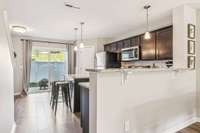 The kitchen bar & island are large enough to add some barstools.