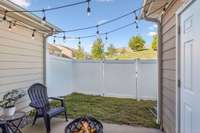 The backyard is fenced in and has a storage unit.