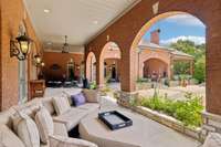 This Picturesque Covered Porch is lit with Carriage House Style Lanterns which give it a soft and elegant glow.