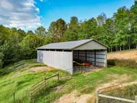 This is the Hay Barn which sits to the Right of the Big Barn. This Property has fencing all over this farm. Great interior trails to ride or walk. Thousands of feet of a spring fed Creek/Branch.