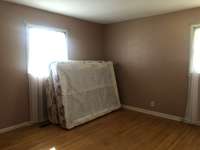 Bedroom with hardwood floors.