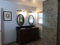 Newly remodeled bathroom has double bowl sinks.