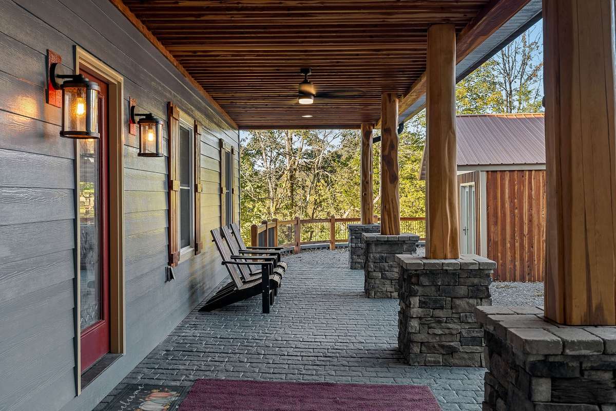 Enjoy this large extra wide covered front porch with stone/cedar post accents, cedar ceiling accents. Porch stretches the full width of home  and offers plenty of space for those rocking chairs.