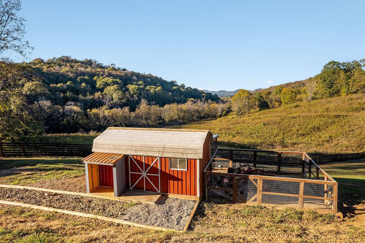 Large chicken coop has large chicken run, storage area, electric/water service and nesting boxes