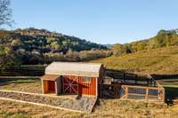Large chicken coop has large chicken run, storage area, electric/water service and nesting boxes
