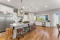 Commercial kitchen with Kitchen Aid appliances and granite counter tops.