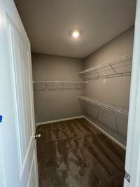 Primary Bedroom closet.  *Photo is from a completed unit of the floor plan. Options and selections may vary in actual property.