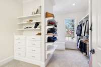 The primary suite features a walk-in closet with built-in shelving and drawers.