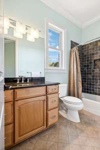 The guest suite feature a private bath with a combination tub and shower and granite counter top.