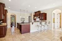 Seen here is the seating area at the kitchen bar. Tile floors are stunning and easy to care for.