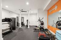 The light and airy home gym is designed to inspire fitness. The rubber flooring provides a safe and durable surface, ideal for various workouts or practicing yoga.