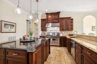 This view of the kitchen captures the large island which offers a tone of additional meal  prep space.
