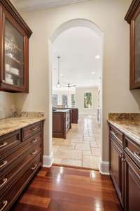 The Butler's pantry serves a stylish and functional transition form dining room to kitchen. Equipped with built-in cabinets this space offers ample storage for fine china and glassware.