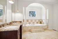 The primary bath features double vanities with granite counter tops and a large soaking tub.