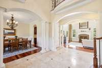 A view of the large formal dining room and the living room can be seen upon entering the foyer. The Brazilian hardwood floors carryover into these two spaces.