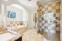 The spacious walk-in shower located in the primary bath is a show stopper.