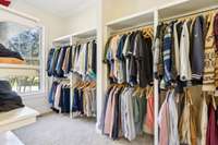 Another view of the primary walk-in closet. This space offers plenty of space for dressing and ample natural light.