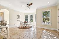 This view of the kitchen shows how large the space is and is home to the eat in kitchen  space. The window trio offers expansive views of the back lawn.