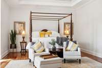 This close up of the sleeping area in the primary suite provides a cozy feel to an otherwise grand room.