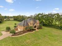 Nestled in the heart of middle Tennessee, this impressive all-brick estate sprawls across nearly 10 acres, offering unparalleled privacy and scenic views.